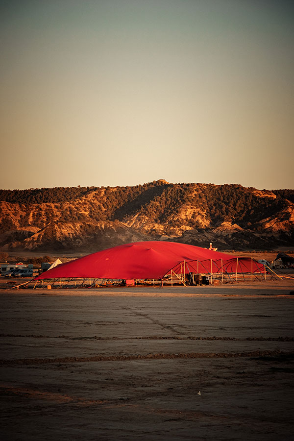 Red shade canopy beneath a rocky ridge at Nowhere