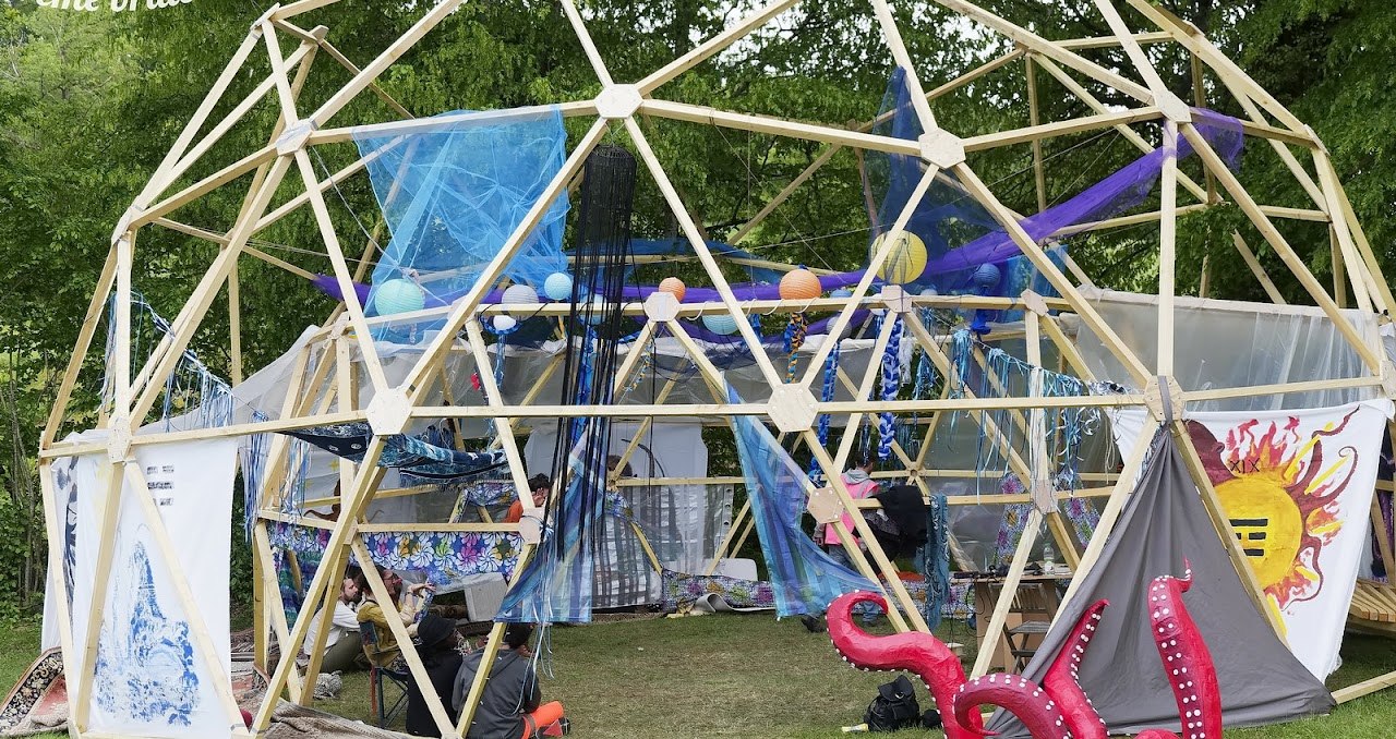 A decorated geodesic dome and camp at Crème Brûlée.