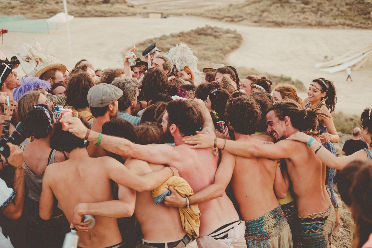 Nowhere participants standing together with their arms around one another