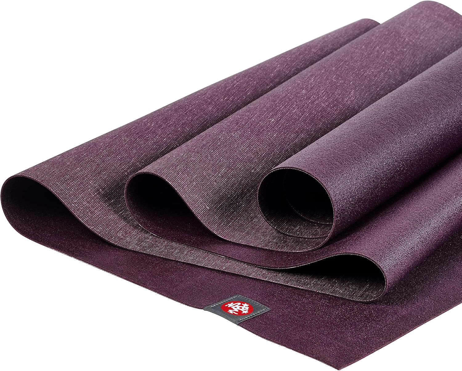 Manduka eKO SuperLite Acai mat arranged in overlapping folds to show its thin profile